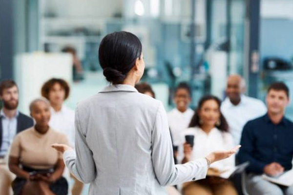 A speaker talks to a attentive room